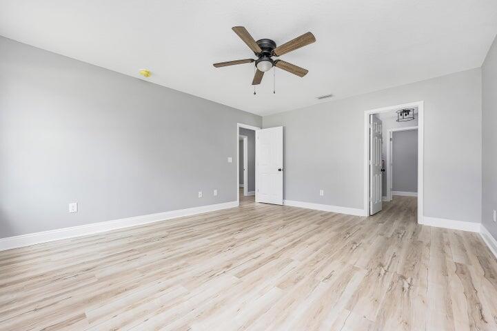 5428 Bayleaf Drive Crestview, FL 32539 - Photo 13 of 23 an empty room with wooden floor and windows
