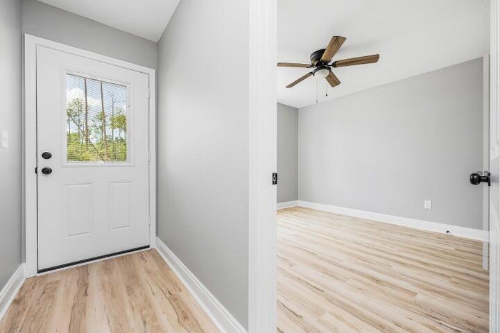 5428 Bayleaf Drive Crestview, FL 32539 - Photo 16 of 23 a view of empty room with wooden floor and ceiling fan