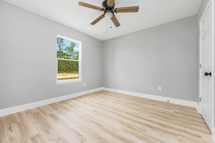 5428 Bayleaf Drive Crestview, FL 32539 - Photo 17 of 23 wooden floor in an empty room with a window