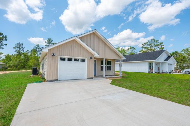 5428 Bayleaf Drive Crestview, FL 32539 - Photo 3 of 23 a view of a house with a yard and large tree