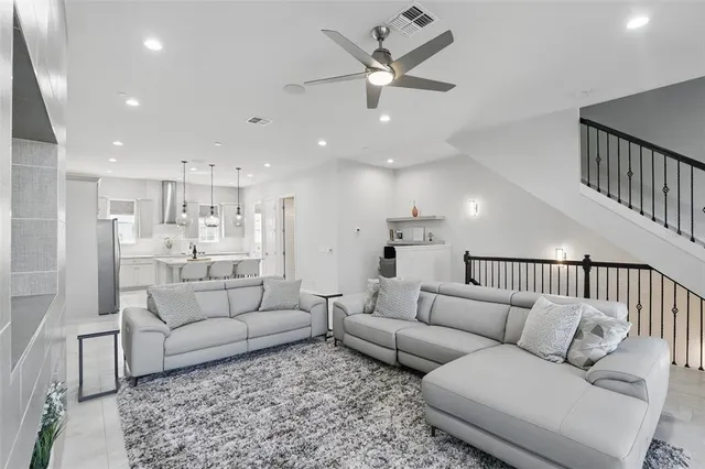 a living room with furniture and kitchen view