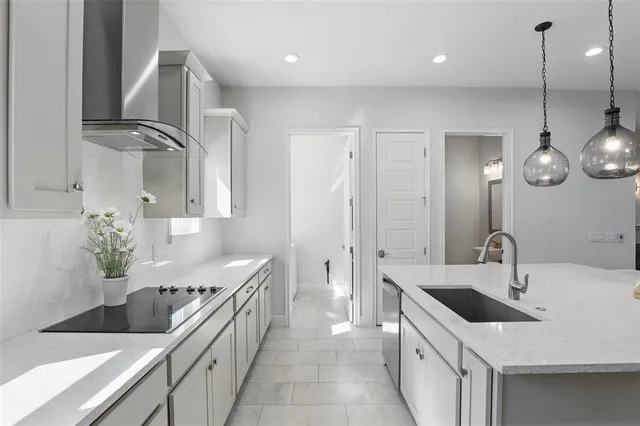 a kitchen with a sink stove and cabinets