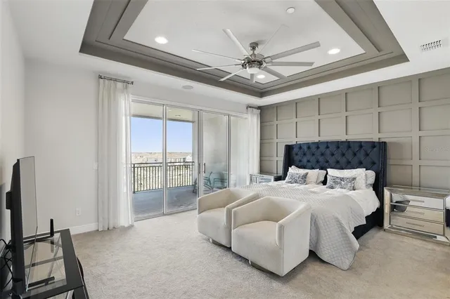 a bedroom with a large bed and a chandelier