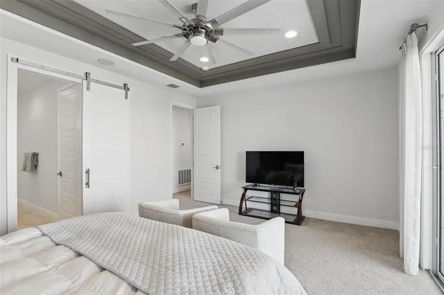 a bedroom with bed and flat screen tv