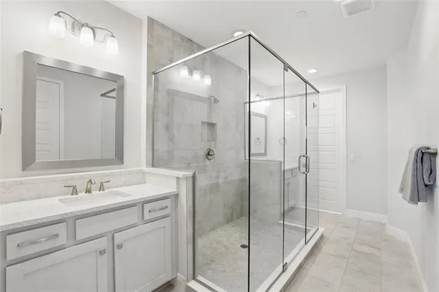 a bathroom with a shower sink and mirror