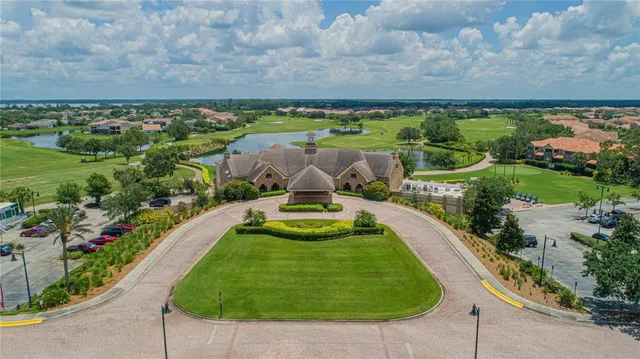 an aerial view of a house with swimming pool and outdoor seating