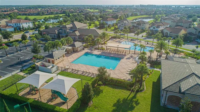 an aerial view of a house with a garden and lake view