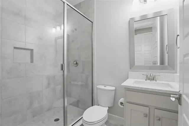 a bathroom with a sink toilet and shower