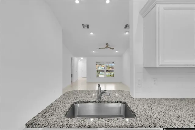 a kitchen with kitchen island a sink stainless steel appliances and a counter top