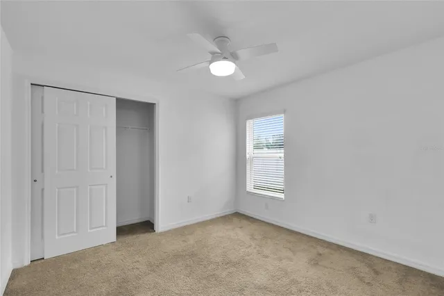 an empty room with windows and closet