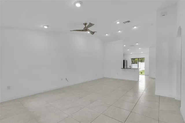 an empty room with a empty space and a ceiling fan