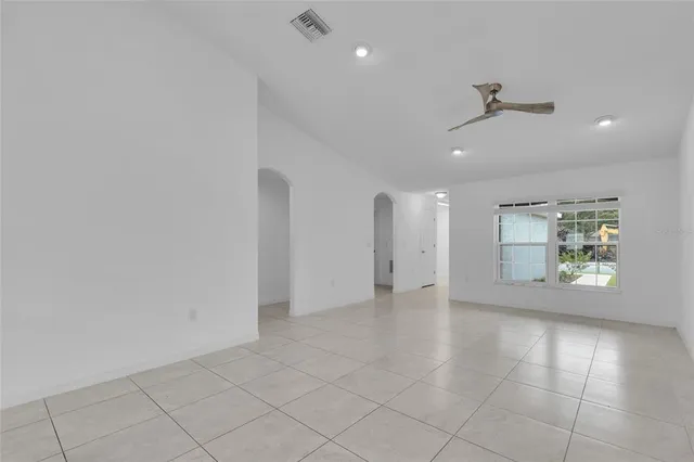 an empty room with entrance and windows