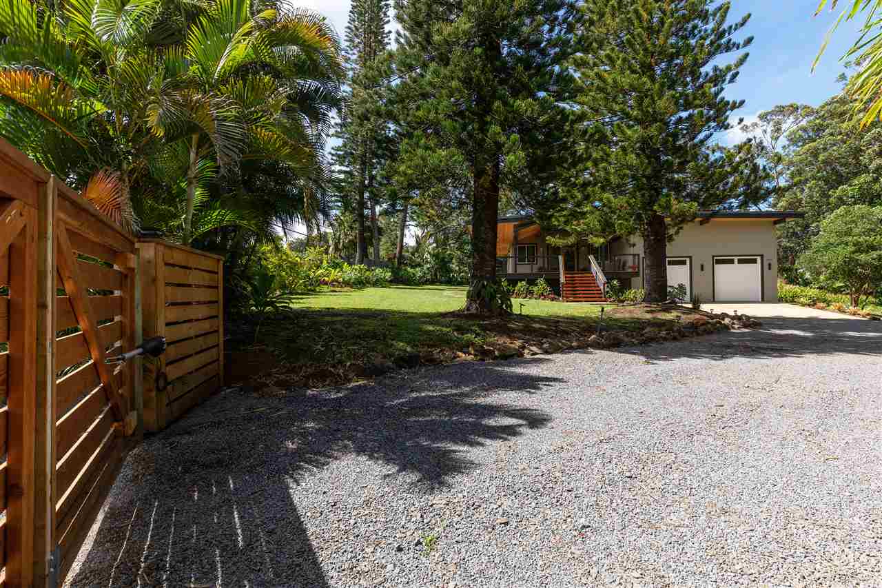 500 Ulumalu Road, Unit A Haiku, HI 96708 - Photo 3 of 30 a backyard of a house with barbeque oven and trees