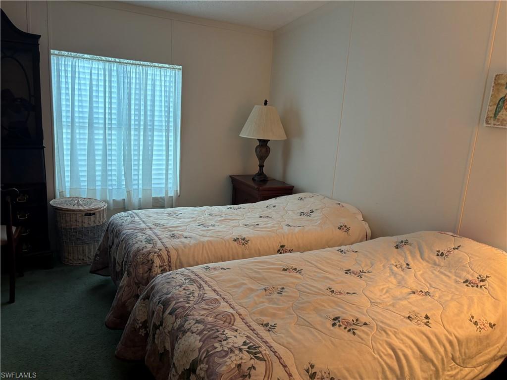 49 Turquoise Avenue, Unit 49T Naples, FL 34114 - Photo 12 of 29 a bedroom with a bed and window