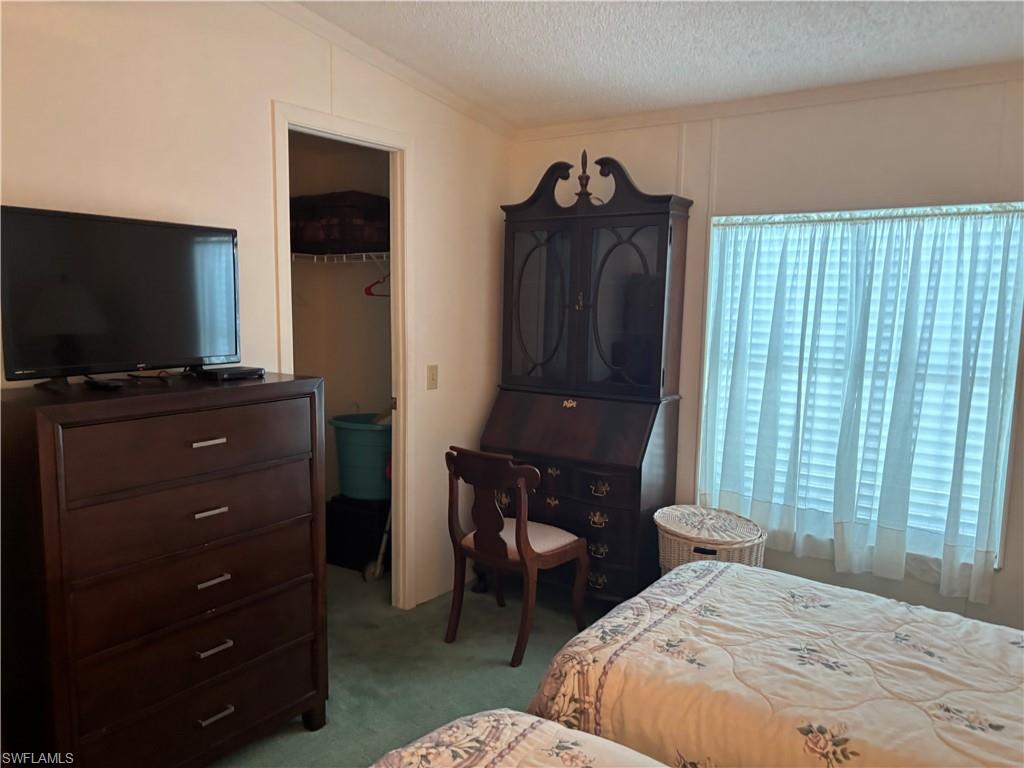 49 Turquoise Avenue, Unit 49T Naples, FL 34114 - Photo 13 of 29 a bedroom with a bed and a television