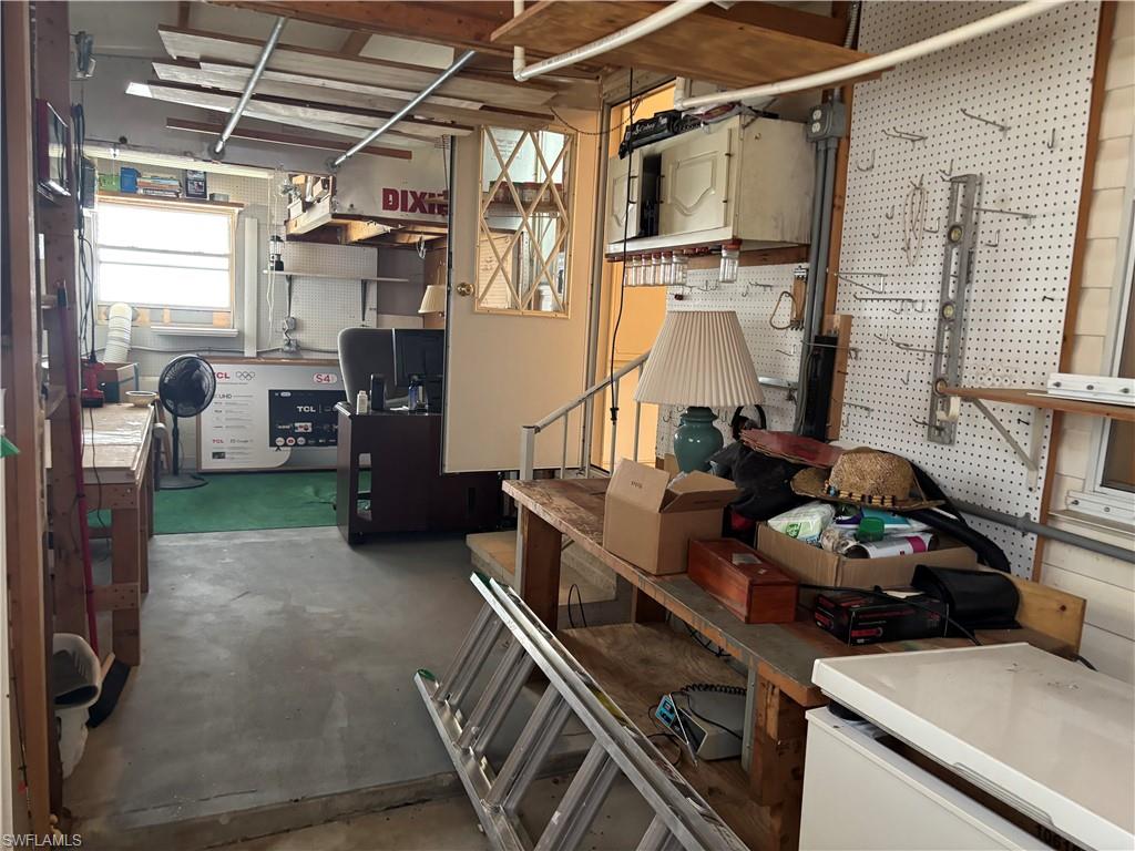 49 Turquoise Avenue, Unit 49T Naples, FL 34114 - Photo 17 of 29 a living room with furniture and a fireplace