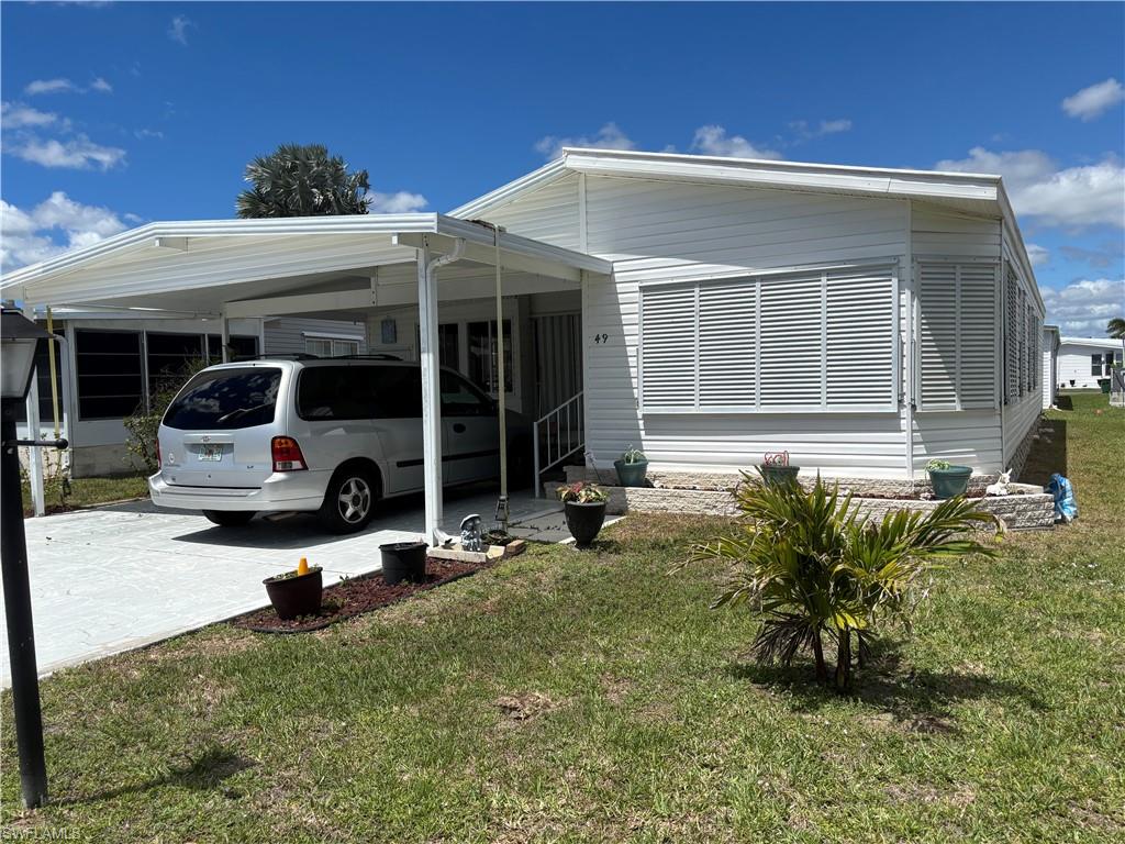 49 Turquoise Avenue, Unit 49T Naples, FL 34114 - Photo 2 of 29 a house view with a garden space
