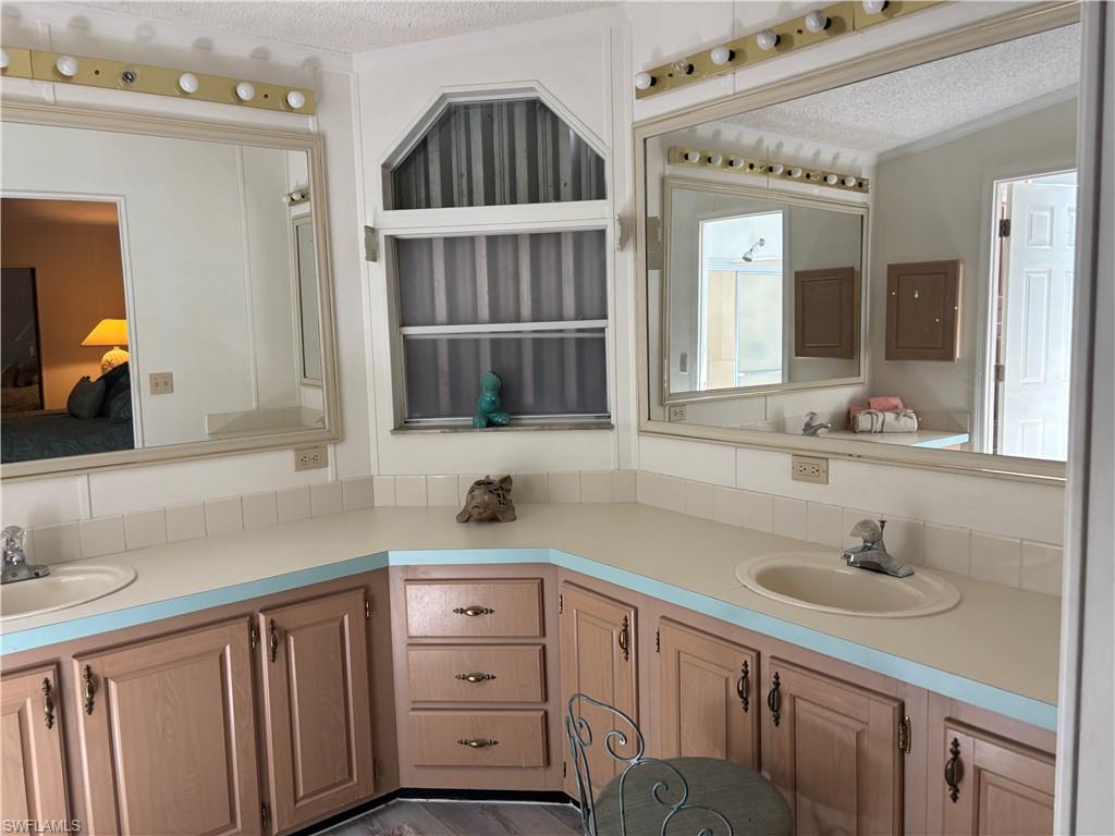 49 Turquoise Avenue, Unit 49T Naples, FL 34114 - Photo 26 of 29 a bathroom with a sink and a mirror