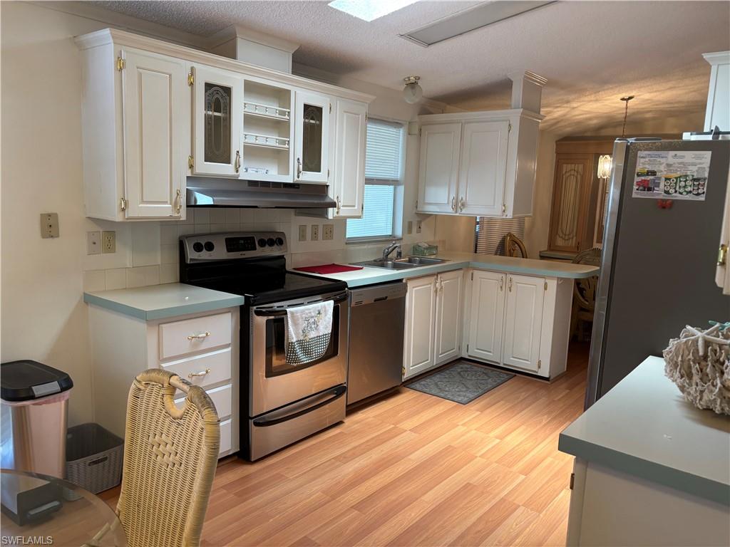 49 Turquoise Avenue, Unit 49T Naples, FL 34114 - Photo 8 of 29 a kitchen with a stove sink and cabinets