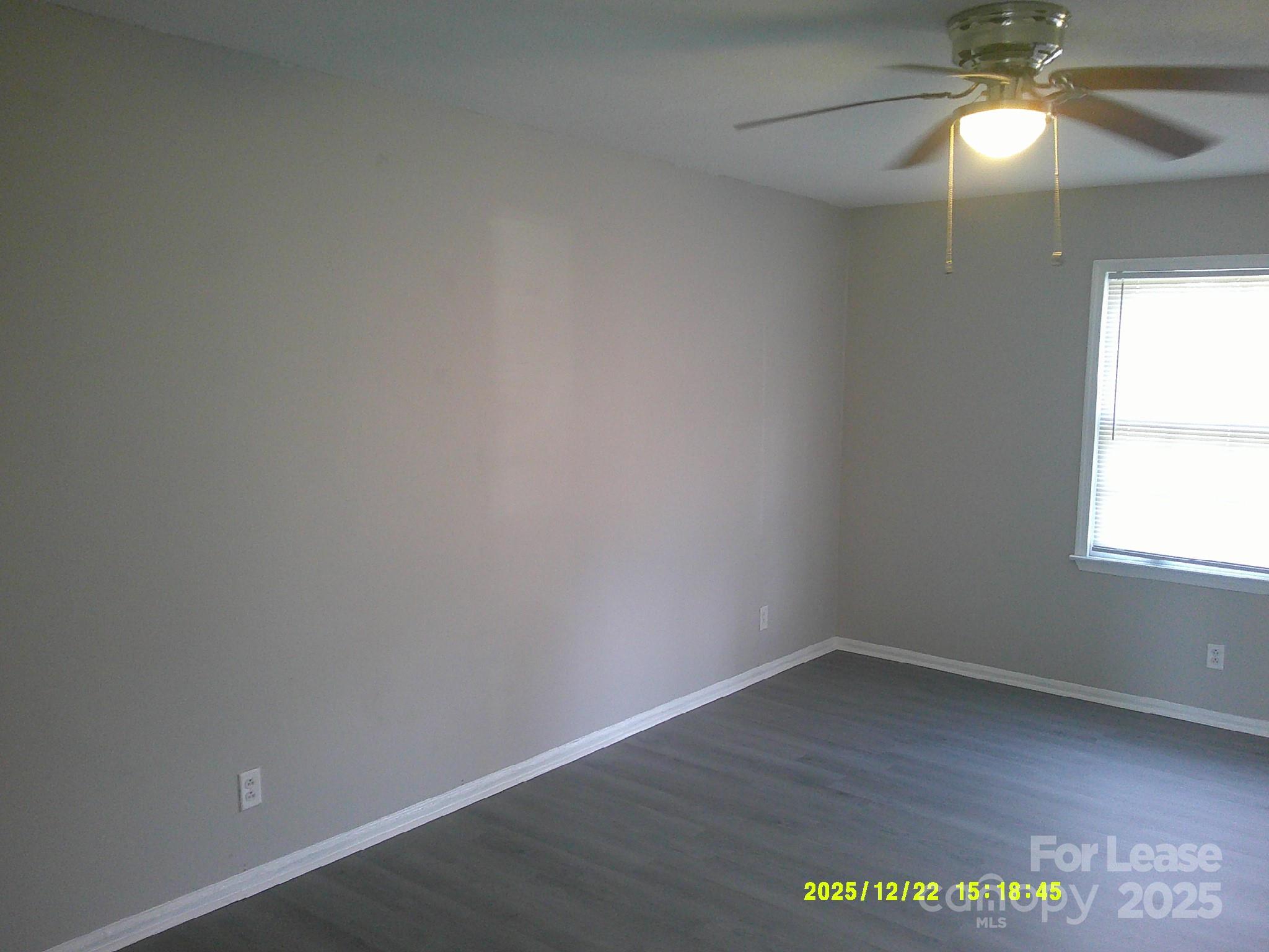 1205 County Home Road, Unit 3 Conover, NC 28613 - Photo 4 of 8 en empty room with a window and wooden floor