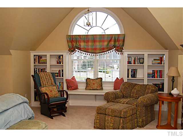 4019 Heathgate Lane Raleigh, NC 27613 - Photo 13 of 24 10 ft ceiling, built-in bookcases & window bench.