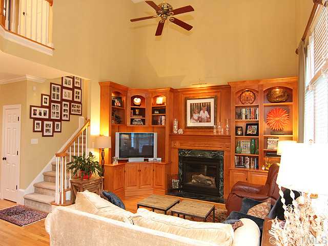 4019 Heathgate Lane Raleigh, NC 27613 - Photo 9 of 24 18 ft. ceiling. Custom built-in cabinets & entertainment center.