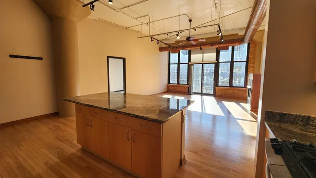 a view of a room with wooden floor
