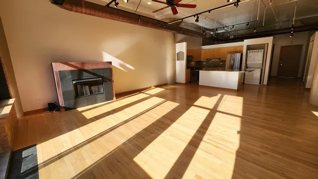 a view of a living room with a fireplace