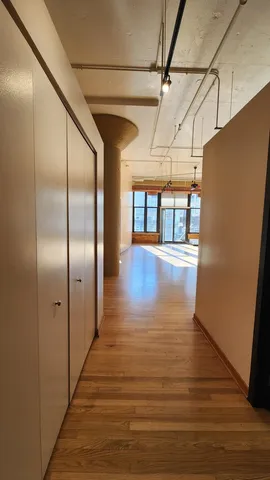 a view of a hallway with wooden floor