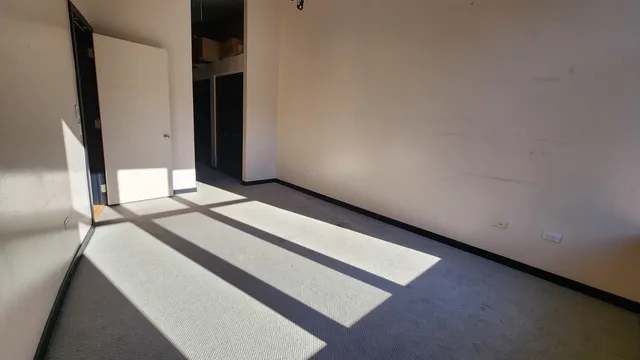 a bedroom with a bed and a mirror