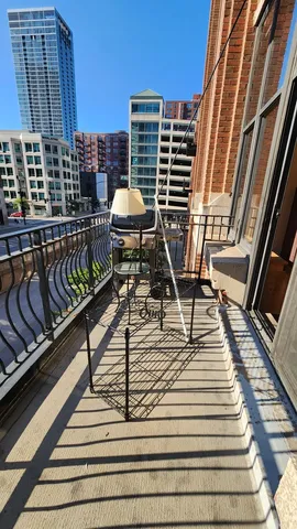 a view of balcony with wooden floor and chairs