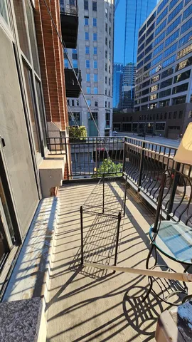 a view of balcony with wooden floor