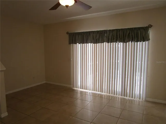 a view of a room with a window and a ceiling fan