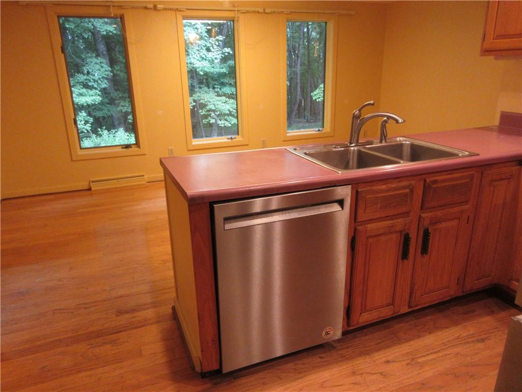 136 Hamel Road Renfrew, PA 16053 - Photo 4 of 18 a kitchen with stainless steel appliances a sink and a window