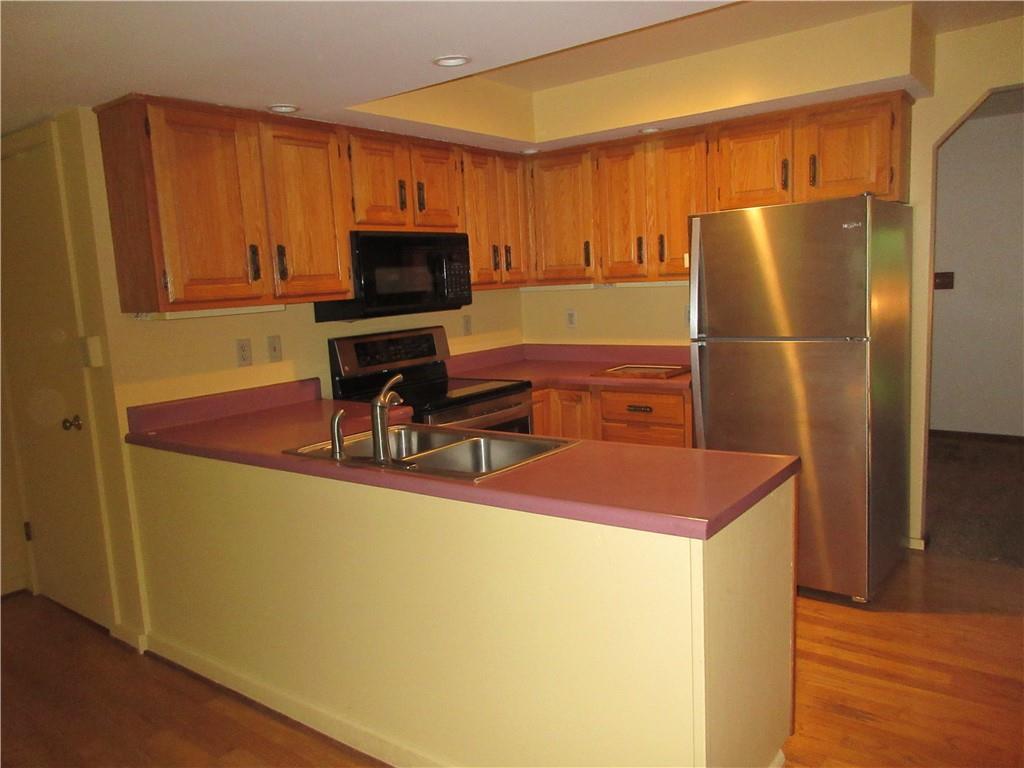 136 Hamel Road Renfrew, PA 16053 - Photo 5 of 18 a kitchen with kitchen island a counter top space cabinets and stainless steel appliances
