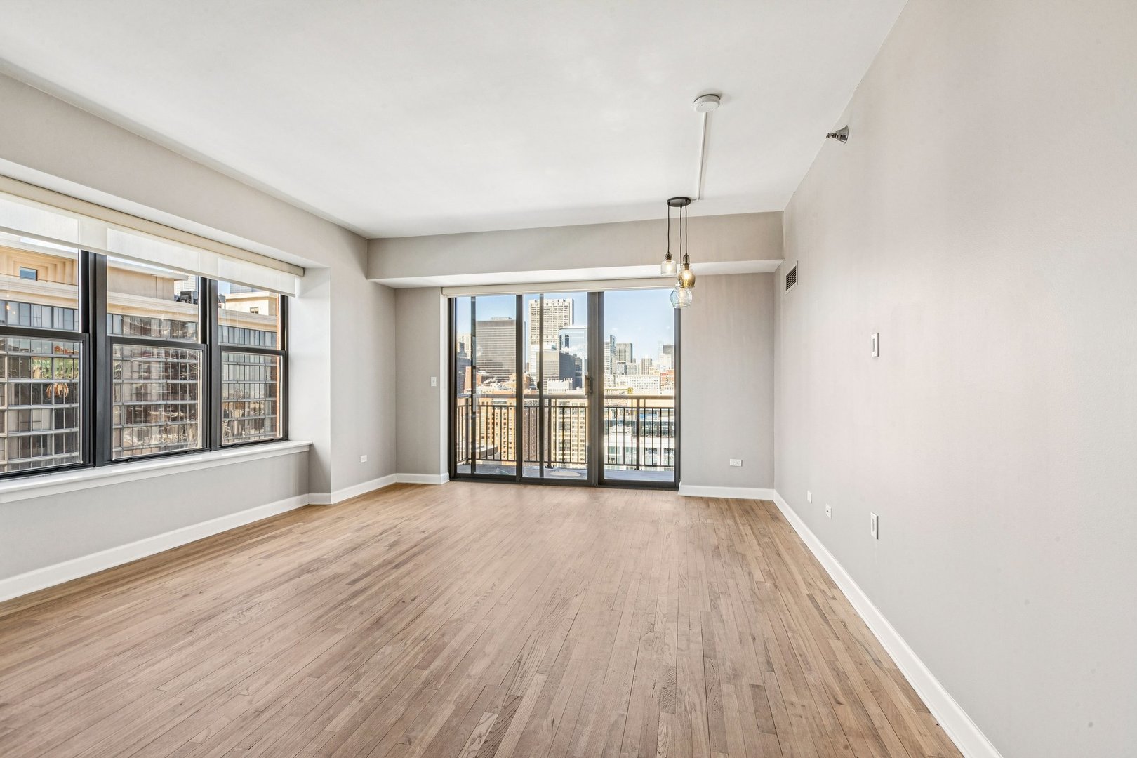 41 East 8th Street, Unit 2207 Chicago, IL 60605 - Photo 21 of 26 a view of an empty room with a window and wooden floor