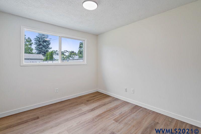 1121 Fabry Road Southeast Salem, OR 97306 - Photo 23 of 31 a view of empty room with wooden floor and fan