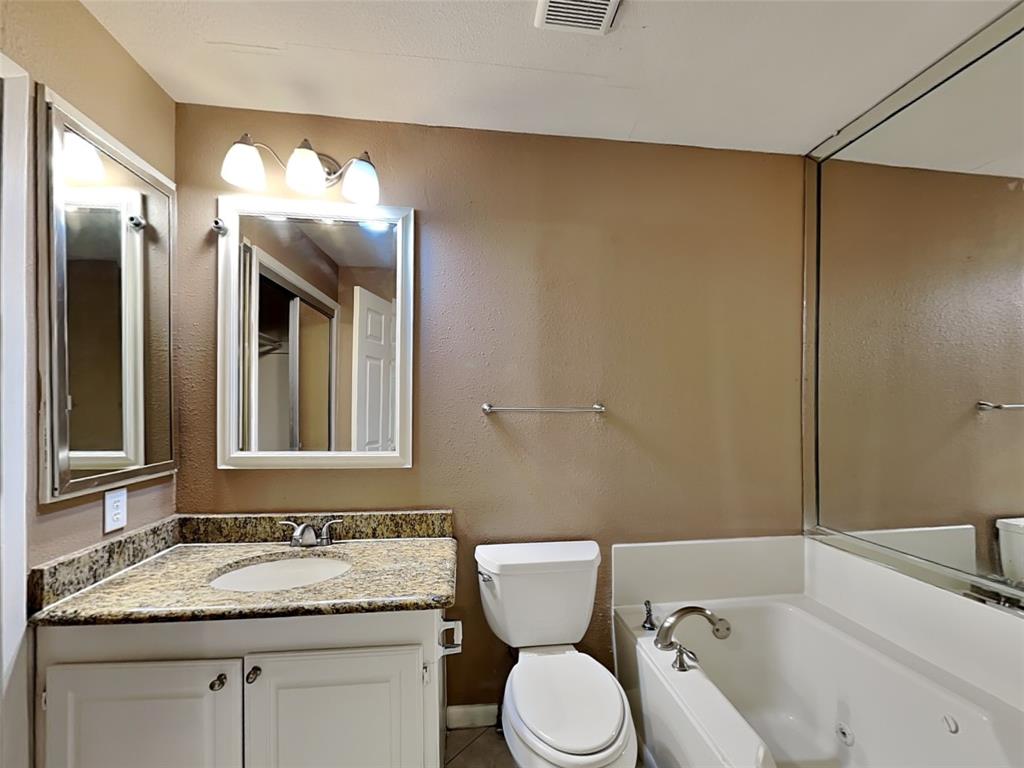107 Laurel Street Lancaster, TX 75134 - Photo 14 of 16 a bathroom with a granite countertop sink and a mirror