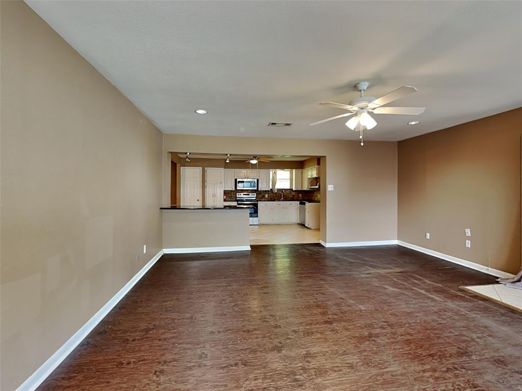 107 Laurel Street Lancaster, TX 75134 - Photo 3 of 16 wooden floor in an empty room with a window