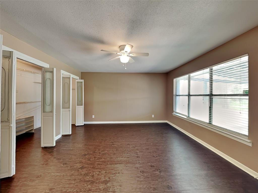 107 Laurel Street Lancaster, TX 75134 - Photo 5 of 16 wooden floor in an empty room with a window