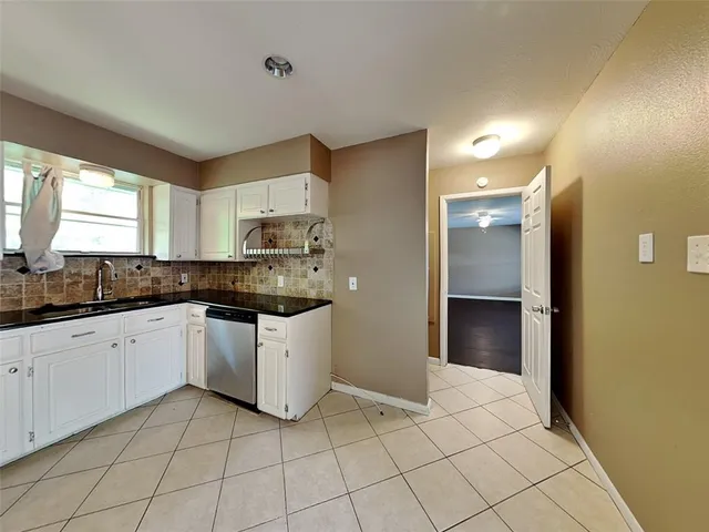 a view of a hallway with cabinet and wooden floor