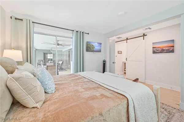 a bedroom with a bed and a chandelier