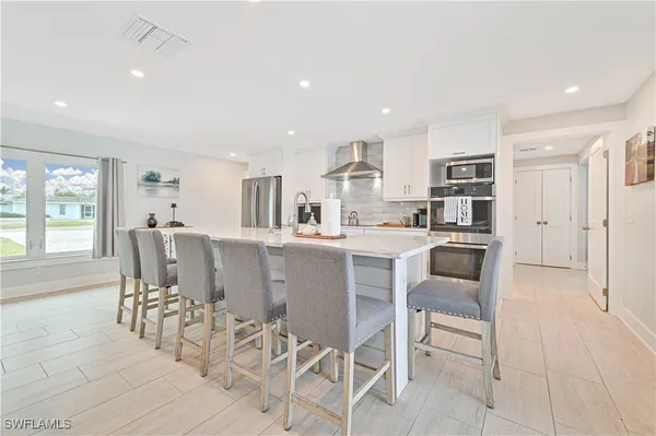 a dining room with furniture and large windows