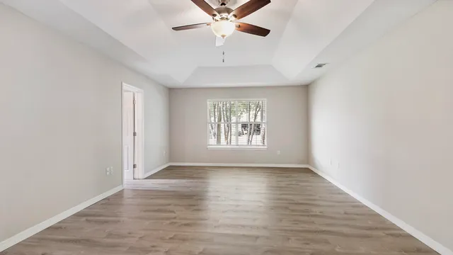 wooden floor in an empty room with a window