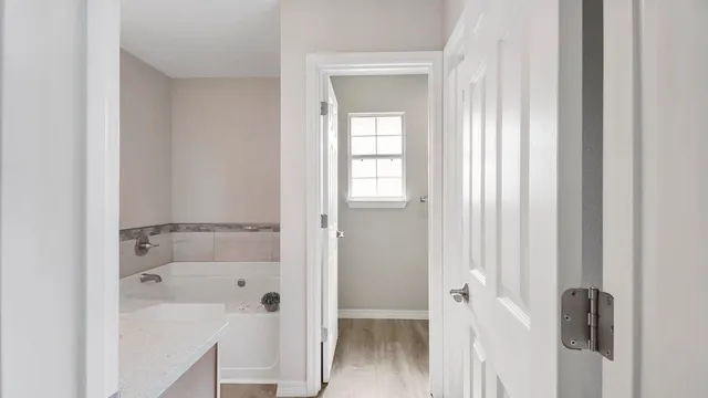 a bathroom with a tub shower and a sink