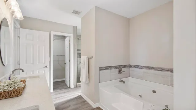a white bath tub sitting next to a sink