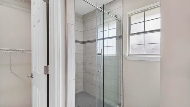 a bathroom with a glass shower door