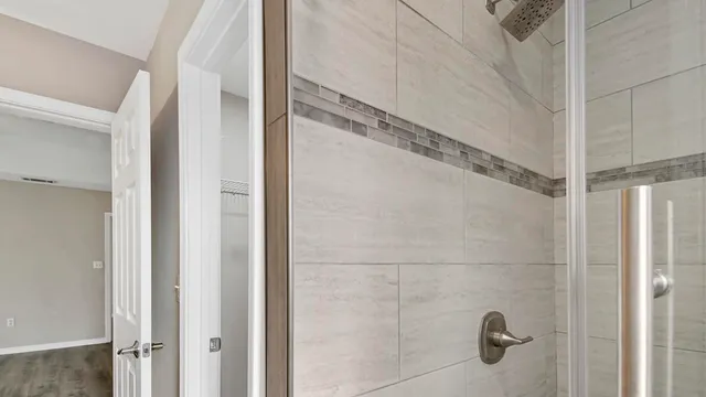 a bathroom with a glass shower door