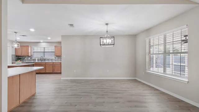 a view of kitchen with wooden floor and windows