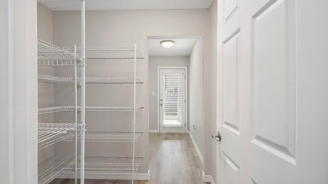 a view of a room with wooden floor and windows